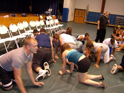 People crawling on stage hypnotized